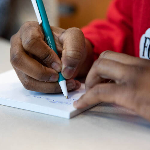 Student writing for a scholarship